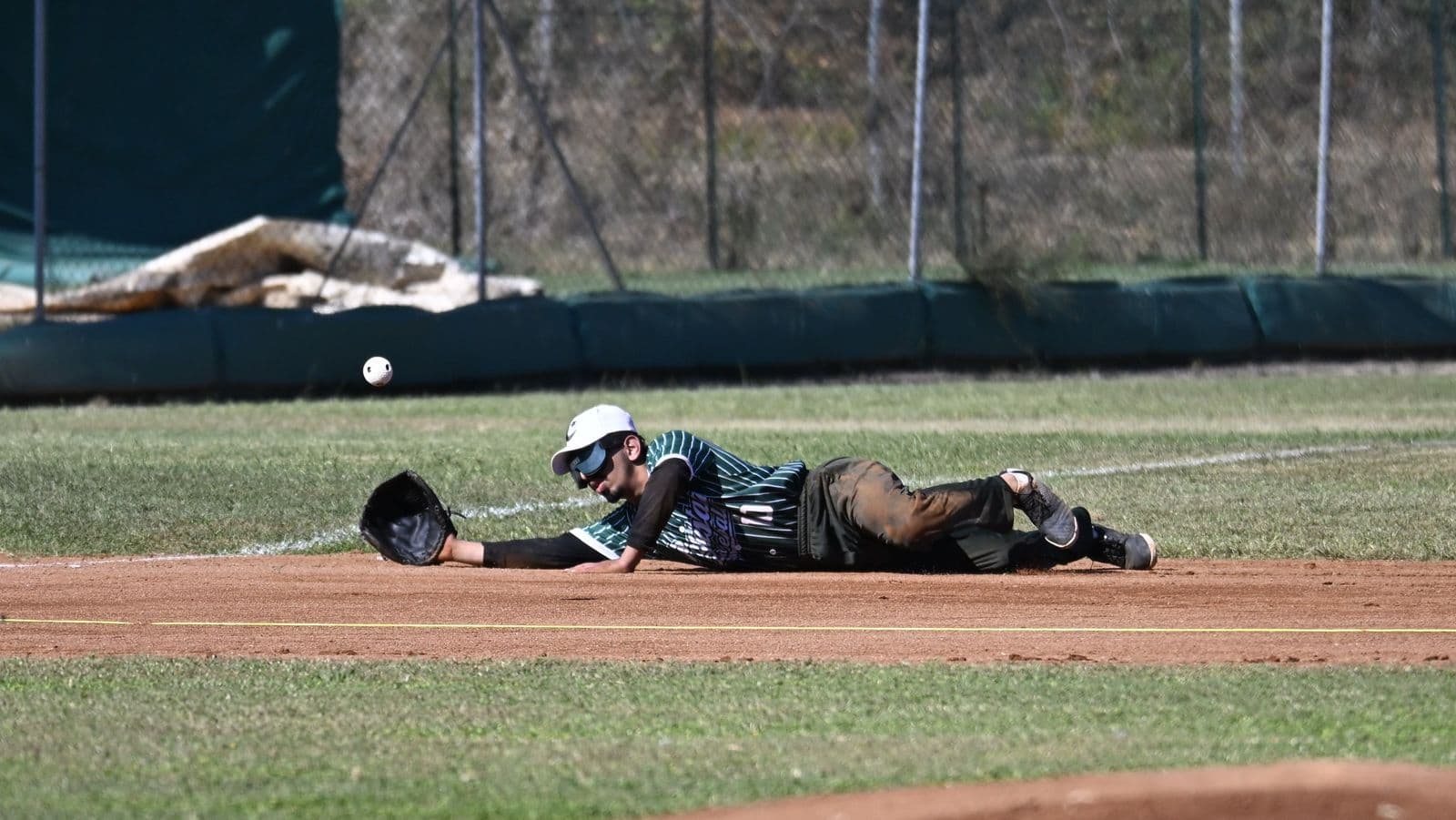 Una defensora de Países Bajos levanta la pelota tras completar la jugada. Foto: WBSC.